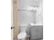 This bathroom has a toilet, sink, vanity, mirror, lighting, and stainless steel towel rack at 5000 Northland Sw Rd, Mableton, GA 30126