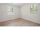 Bedroom with wood-look floors, two windows, and neutral-colored walls at 5000 Northland Sw Rd, Mableton, GA 30126