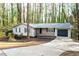 Charming single-story home with a well-maintained lawn, long driveway, and an attached garage, curb appeal at 5000 Northland Sw Rd, Mableton, GA 30126