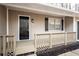 Inviting covered front porch with black door and details, and a wood trimmed railing at 5000 Northland Sw Rd, Mableton, GA 30126