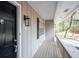 Covered front porch features traditional details including a black door, lantern, and house number at 5000 Northland Sw Rd, Mableton, GA 30126