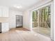 Bright kitchen with stainless steel refrigerator, white cabinetry and sliding doors to a deck at 5000 Northland Sw Rd, Mableton, GA 30126