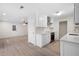 Kitchen open to the living room, with white cabinets, stainless steel appliances, and a light-colored countertop at 5000 Northland Sw Rd, Mableton, GA 30126