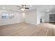 Open floorplan showcasing hardwood floors, a ceiling fan, and a well-lit kitchen with stainless steel appliances at 5000 Northland Sw Rd, Mableton, GA 30126