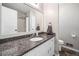 Bathroom with a granite countertop, single sink vanity, and a large mirror at 7060 Steel Wood Nw Dr, Kennesaw, GA 30152