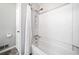 Modern bathtub with white shower curtain and tiled walls at 7060 Steel Wood Nw Dr, Kennesaw, GA 30152