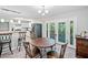 Open dining area with barstool seating and seamless flow to the modern kitchen at 7060 Steel Wood Nw Dr, Kennesaw, GA 30152