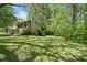 Charming home with a covered porch and lush greenery, set on a well-maintained lawn at 7060 Steel Wood Nw Dr, Kennesaw, GA 30152