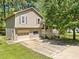 Charming two-story home with a well-maintained lawn and attached one car garage at 7060 Steel Wood Nw Dr, Kennesaw, GA 30152