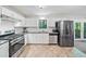 Bright kitchen with stainless steel appliances, white cabinets, and plenty of counter space at 7060 Steel Wood Nw Dr, Kennesaw, GA 30152