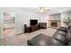 Comfortable living room featuring a stone fireplace, plush carpeting, and modern entertainment center at 7060 Steel Wood Nw Dr, Kennesaw, GA 30152