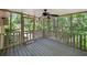 Relaxing screened porch with ceiling fan and view of the backyard at 7060 Steel Wood Nw Dr, Kennesaw, GA 30152