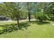 Expansive front yard offering generous space and curb appeal surrounded by mature trees at 7060 Steel Wood Nw Dr, Kennesaw, GA 30152