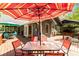 Outdoor back deck features dining and seating areas, complete with a red and white striped umbrella at 175 Flat Creek Ct, Fayetteville, GA 30214