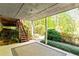 Covered back porch with stairs and a view of lush landscaping at 175 Flat Creek Ct, Fayetteville, GA 30214