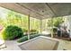 Covered back porch includes a decorative rug and has a view of the trees at 175 Flat Creek Ct, Fayetteville, GA 30214