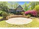 A large stone patio looks onto a backyard with beautiful landscaping around the house at 175 Flat Creek Ct, Fayetteville, GA 30214
