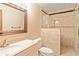 Well-designed bathroom features a vanity, toilet, and a tiled shower with mosaic accents, offering a stylish space at 175 Flat Creek Ct, Fayetteville, GA 30214