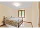 This bedroom has a double bed and a window that provides natural light and is complemented by neutral walls at 175 Flat Creek Ct, Fayetteville, GA 30214