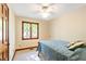 Charming bedroom featuring a double bed, a decorative window, and a ceiling fan, offering a cozy retreat at 175 Flat Creek Ct, Fayetteville, GA 30214