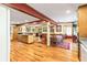 Open-concept dining area features beautiful hardwood floors, ceiling beams, and a view into the kitchen at 175 Flat Creek Ct, Fayetteville, GA 30214