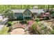 Back exterior of the home showcasing tiered deck, screened porch, and beautiful landscaping at 175 Flat Creek Ct, Fayetteville, GA 30214