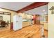 Spacious kitchen features wood cabinets, gas range, breakfast area, and hardwood floors, creating a warm atmosphere at 175 Flat Creek Ct, Fayetteville, GA 30214