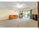Cozy living room features a fireplace, sliding doors to a lush backyard, and neutral decor at 175 Flat Creek Ct, Fayetteville, GA 30214