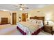 Large main bedroom boasts generous space, ceiling fan, neutral carpet, and ample natural light from various windows at 175 Flat Creek Ct, Fayetteville, GA 30214