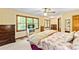 Bright main bedroom showcases natural light, a ceiling fan, and well-placed dressers for efficient storage at 175 Flat Creek Ct, Fayetteville, GA 30214