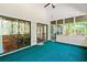 Relaxing screened porch featuring sliding glass doors with a dining area and leafy view at 175 Flat Creek Ct, Fayetteville, GA 30214