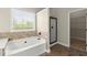 Bathroom featuring a soaking tub with tile backsplash, a shower, and a walk in closet at 2238 Well Springs Dr, Buford, GA 30519