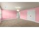 Spacious pink bedroom with a decorative light fixture, a closet, and a doorway at 2238 Well Springs Dr, Buford, GA 30519