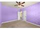 Purple bedroom featuring a decorative light fixture and doors leading to other areas at 2238 Well Springs Dr, Buford, GA 30519