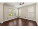 Cozy bedroom featuring neutral walls, wood floors, and ample natural light from multiple windows at 2238 Well Springs Dr, Buford, GA 30519