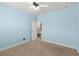 Bright bedroom with light blue walls, ceiling fan, and neutral carpet at 2238 Well Springs Dr, Buford, GA 30519