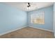 Blue bedroom featuring a ceiling fan, window and neutral carpet at 2238 Well Springs Dr, Buford, GA 30519