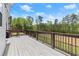 Spacious deck with black metal railings offering views of trees and blue skies at 2238 Well Springs Dr, Buford, GA 30519