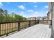 Spacious deck with black metal railings offering views of trees and blue skies at 2238 Well Springs Dr, Buford, GA 30519