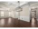 Spacious dining room with hardwood floors, wainscoting, coffered ceilings and contemporary lighting at 2238 Well Springs Dr, Buford, GA 30519