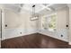 Elegant dining room featuring wood floors, decorative trim, and modern lighting fixture at 2238 Well Springs Dr, Buford, GA 30519