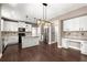 Bright kitchen with white cabinets, an island with seating, stainless appliances and stylish backsplash at 2238 Well Springs Dr, Buford, GA 30519