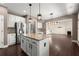 Open kitchen concept with granite island, stainless appliances and sight lines to the living room at 2238 Well Springs Dr, Buford, GA 30519