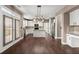 Kitchen features white cabinetry, stainless appliances, a granite island, and direct access to the patio at 2238 Well Springs Dr, Buford, GA 30519