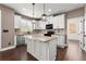 Open kitchen with a granite island, stainless appliances, ample storage and natural light from the window at 2238 Well Springs Dr, Buford, GA 30519