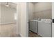 Laundry room with machines, a wire shelf, and a view into another room at 2238 Well Springs Dr, Buford, GA 30519