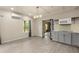 Open living area with grey cabinets, and modern appliances, and wood-look floors at 2238 Well Springs Dr, Buford, GA 30519