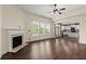 Open-concept living room with hardwood floors, fireplace, and seamless access to kitchen at 2238 Well Springs Dr, Buford, GA 30519