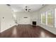 Bright living room featuring hardwood floors, a fireplace, and natural light from large windows at 2238 Well Springs Dr, Buford, GA 30519