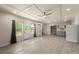 Open living area with wood-look floors, large windows, and a modern kitchen at 2238 Well Springs Dr, Buford, GA 30519